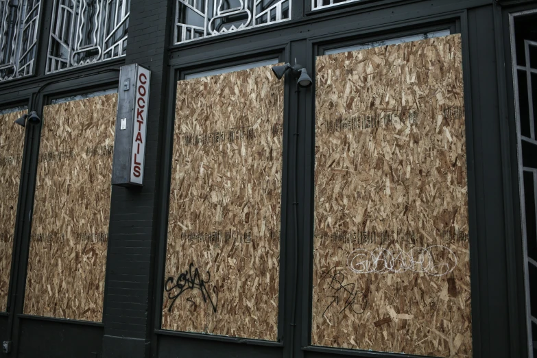 a boarded up wall in front of a building