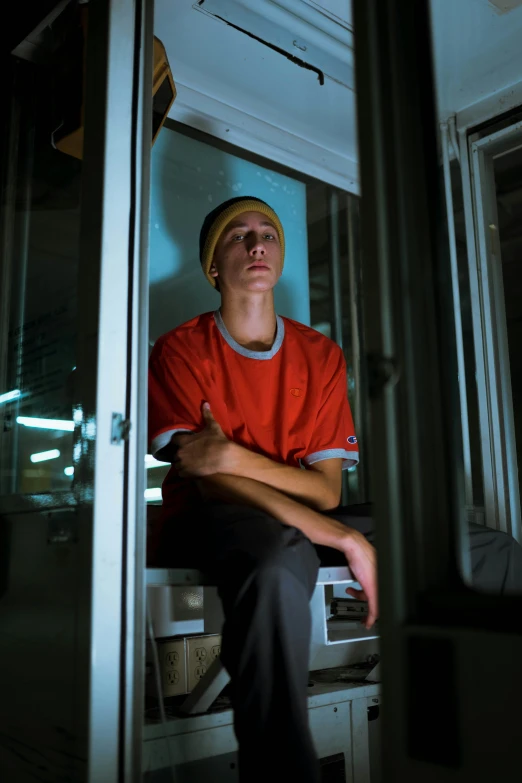 the man is sitting in front of his microwave