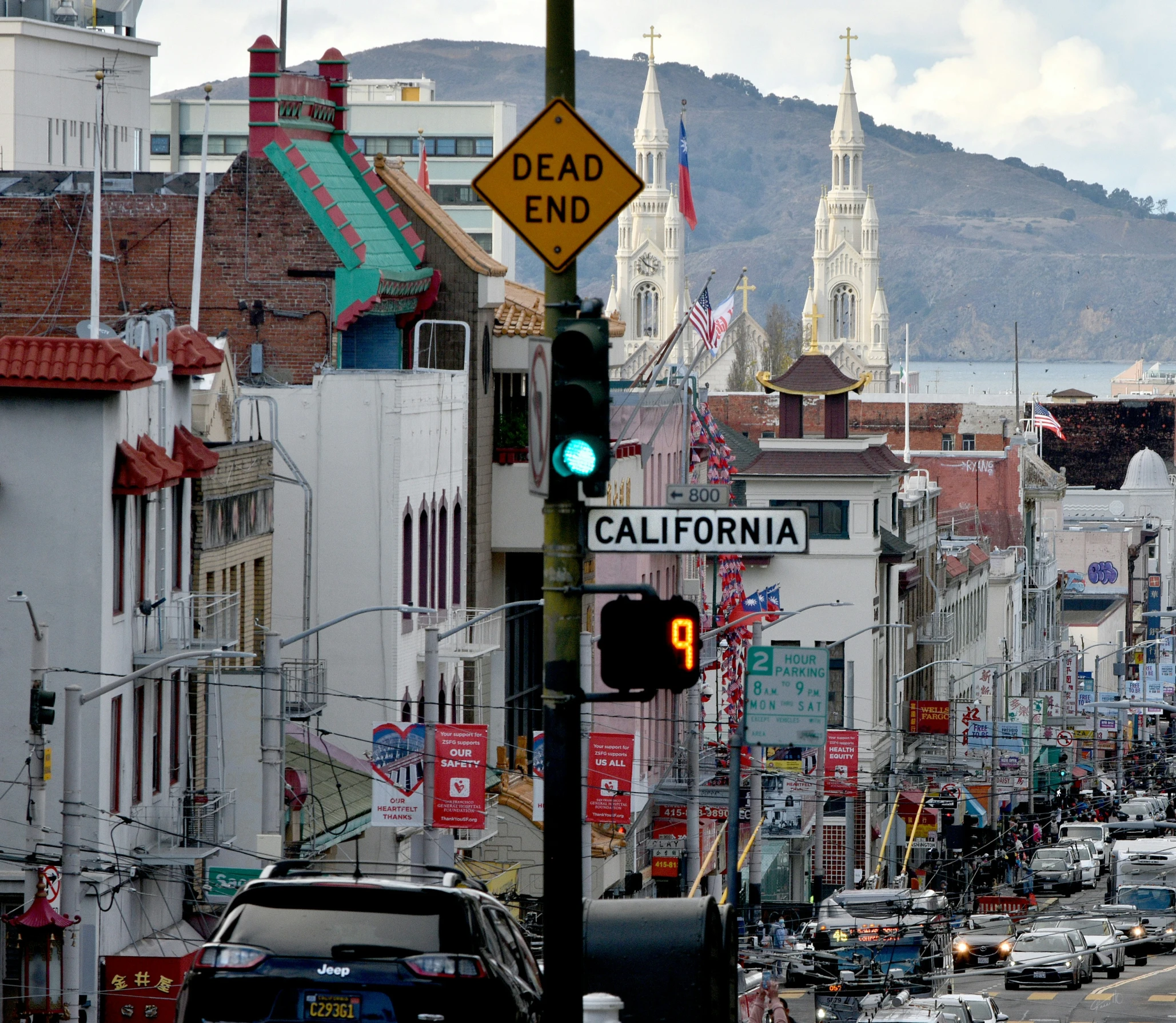 traffic lights and signs on a busy street in california