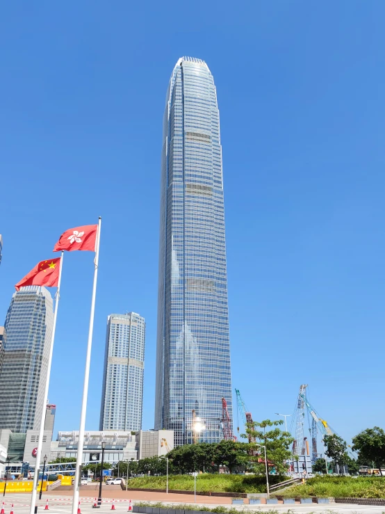 a couple of flags are standing in front of some buildings