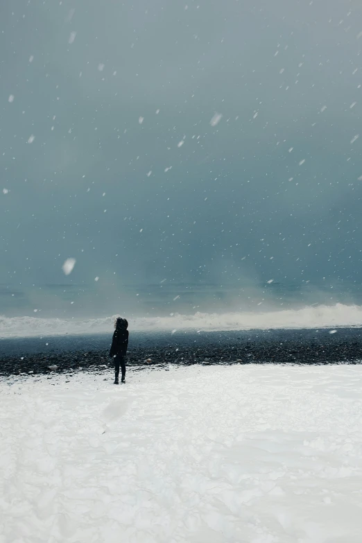 person on the snow with ocean in background