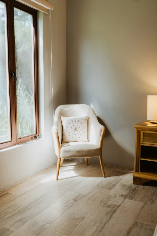 a large wooden chair sitting in front of a window