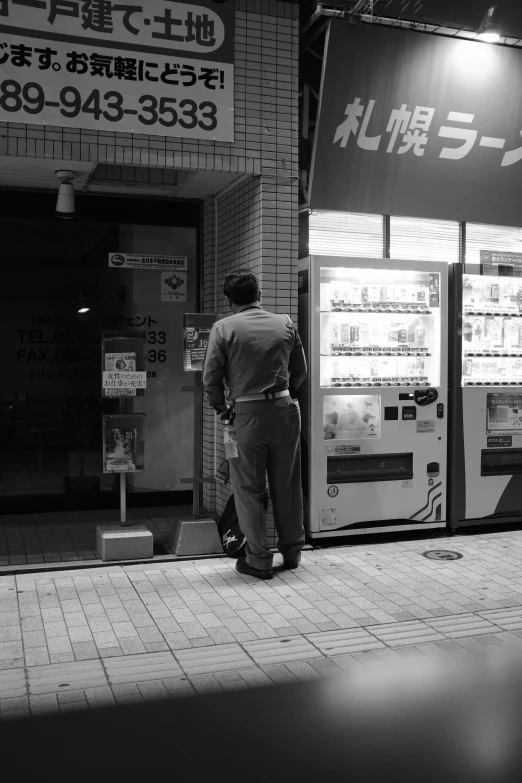 a man standing in front of a vending machine