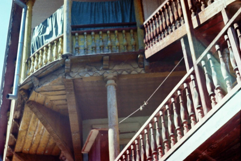 a picture of a balcony and stairs with curtains