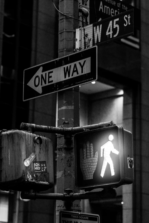 a one way sign sitting in front of a street sign