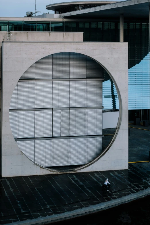 a large circular sculpture on the side of a building