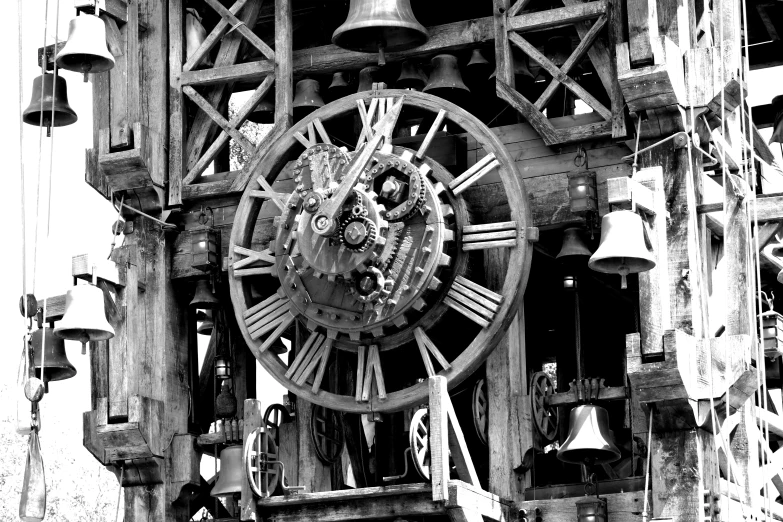 a large wooden clock with lots of bells