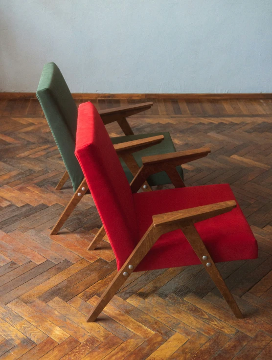 a stack of four modern lounge chairs on wood floors