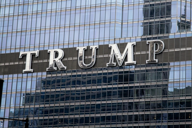 trump building is reflected in the glass windows