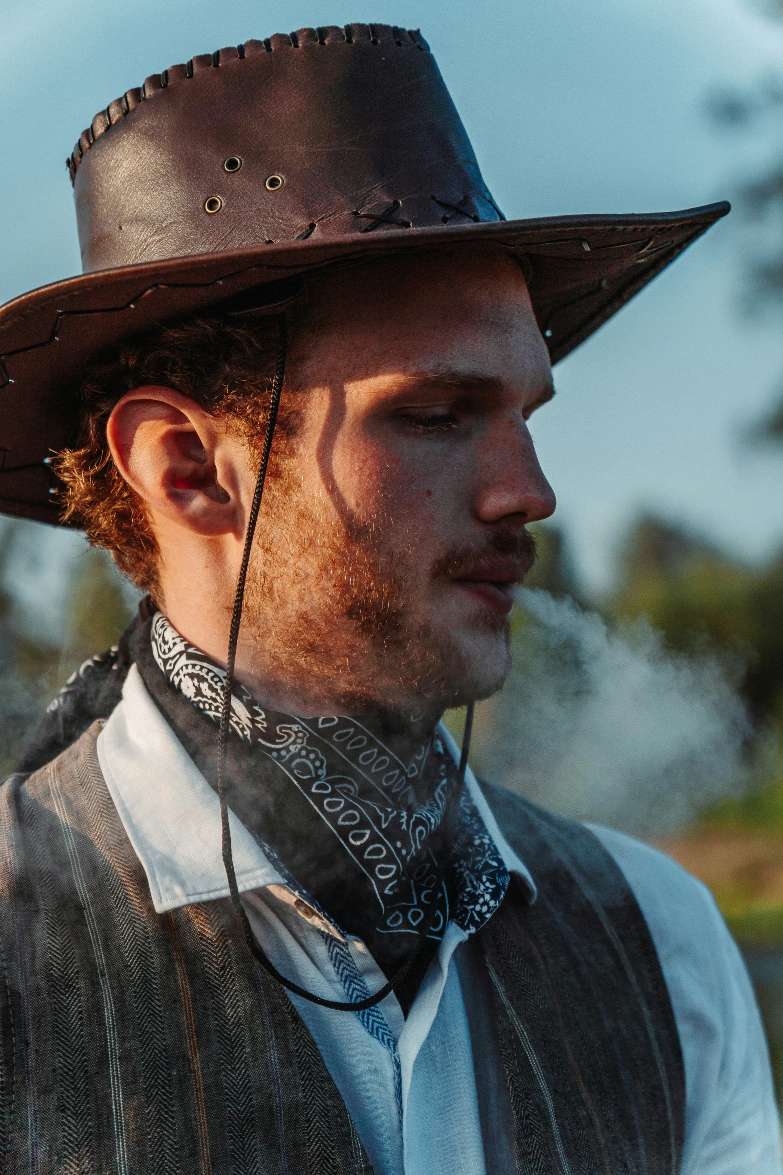 a young man wearing an old west cowboy hat