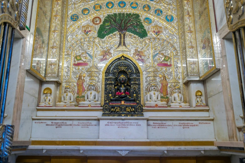 a large ornate golden building with columns and carvings