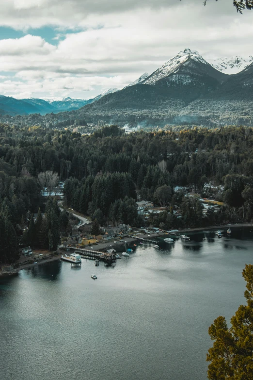 a beautiful scene with a dock and mountains