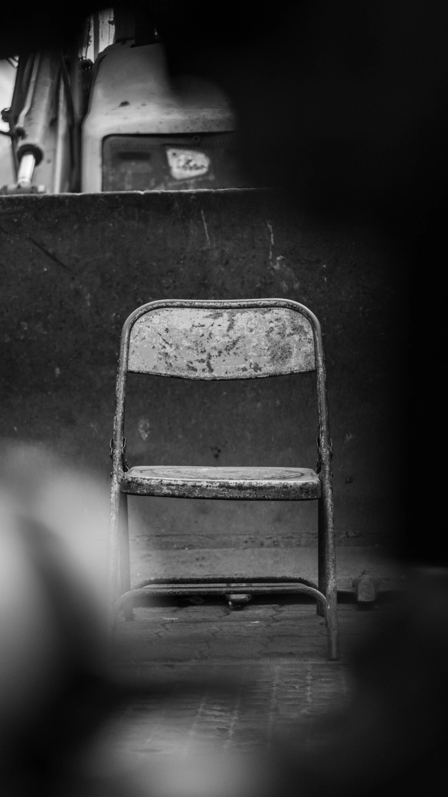 a black and white po of a chair sitting in the corner