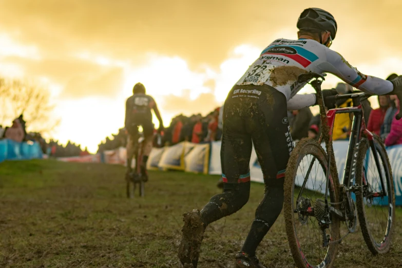 cyclists passing each other in a muddy race