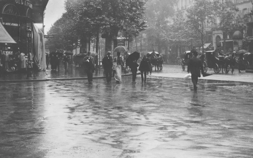 a group of people are standing on a wet street