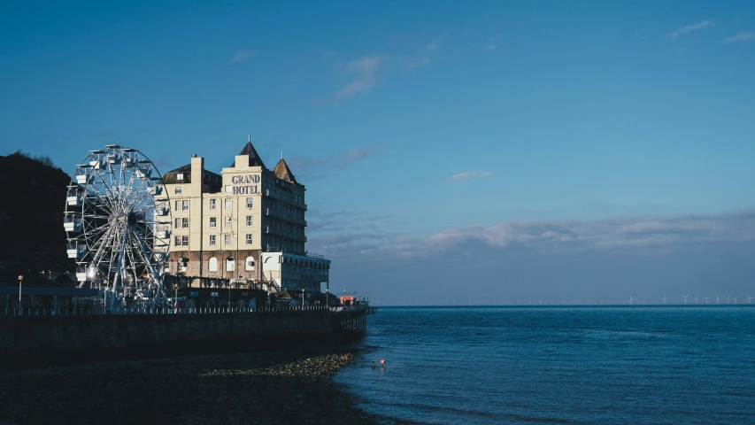 a large building is in front of the water