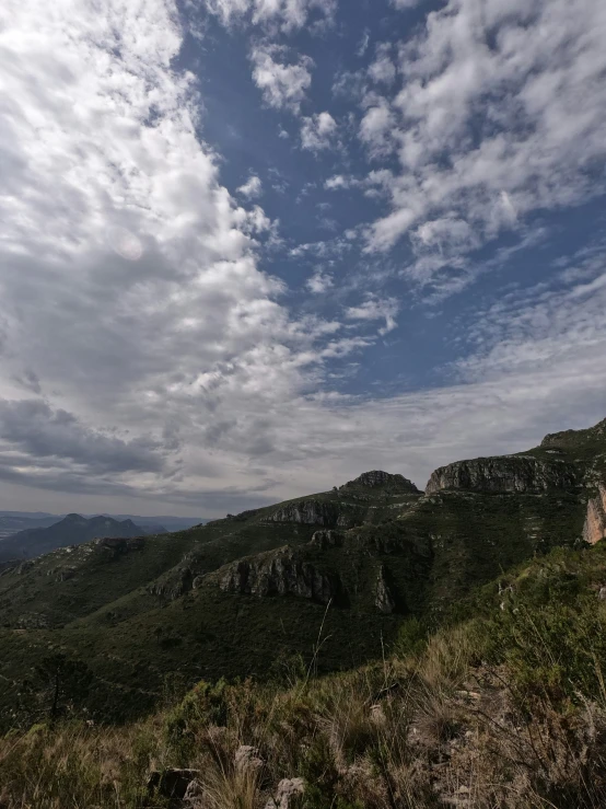 a person is on a small mountain, as a cloud descends