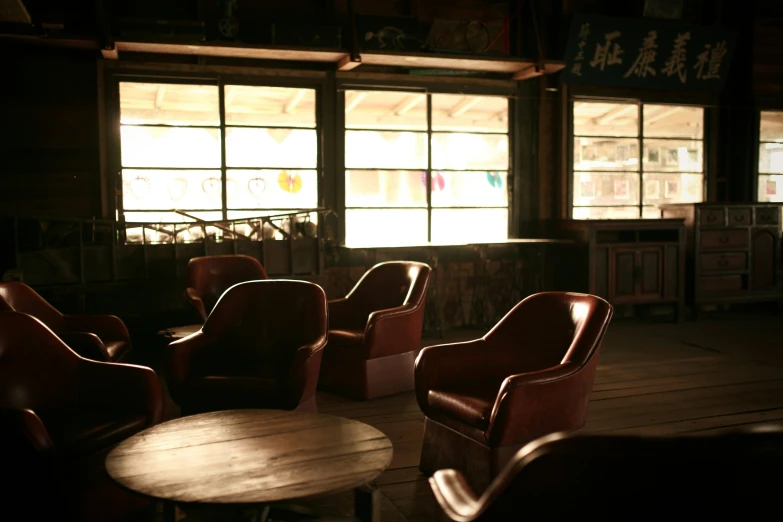 a dark and lit room with many chairs