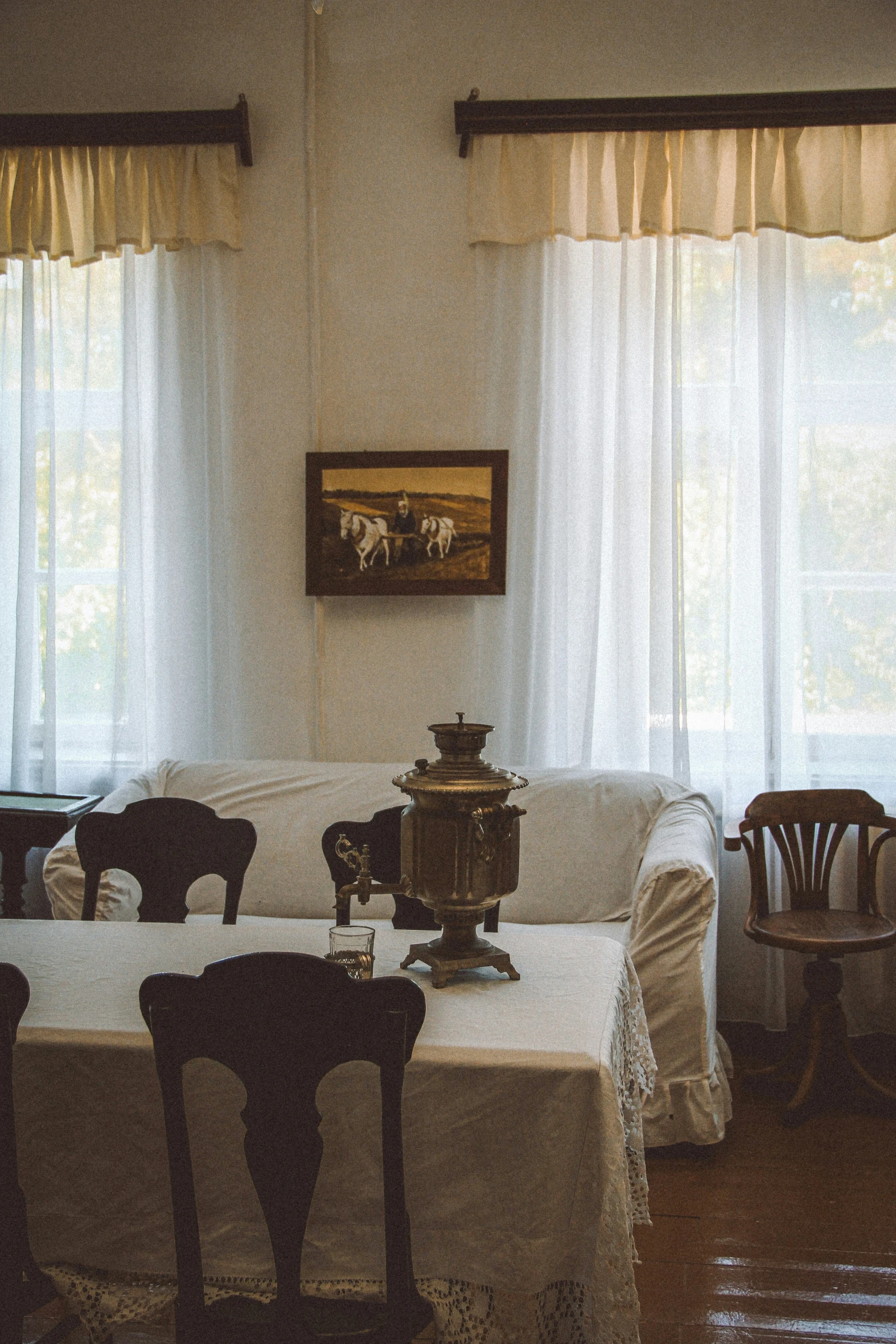 a living room with three chairs and an table