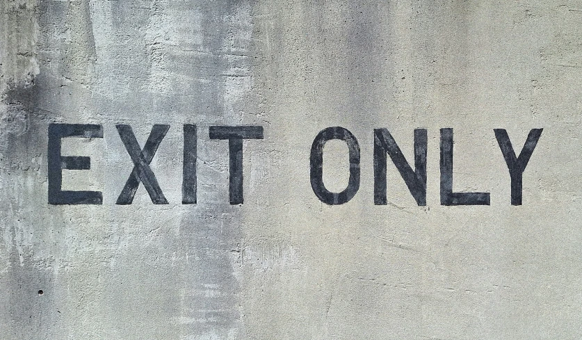 an exit only sign painted on a wall