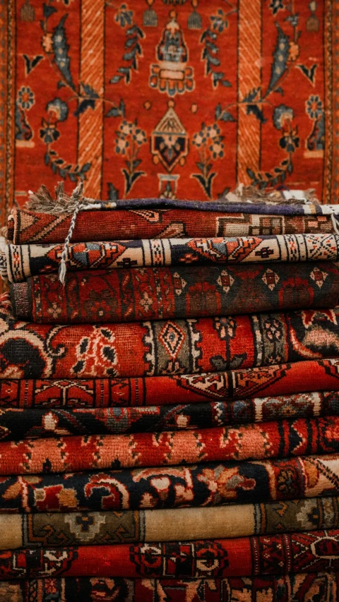 five persian rugs are stacked side by side