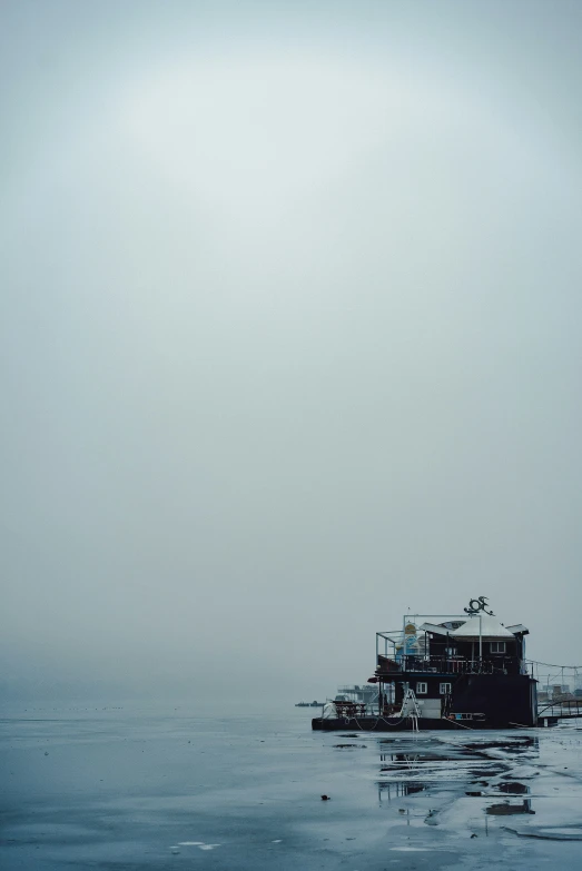 an ocean vessel in the water on a very hazy day