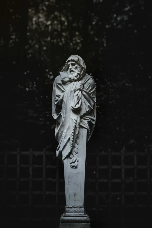 a statue of a man in white clothes standing on his hand