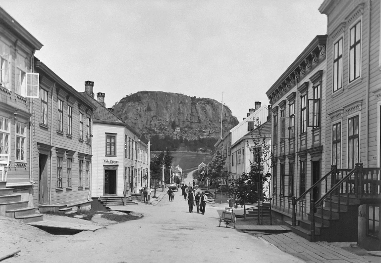 a view of a street scene of many buildings with a mountain in the background