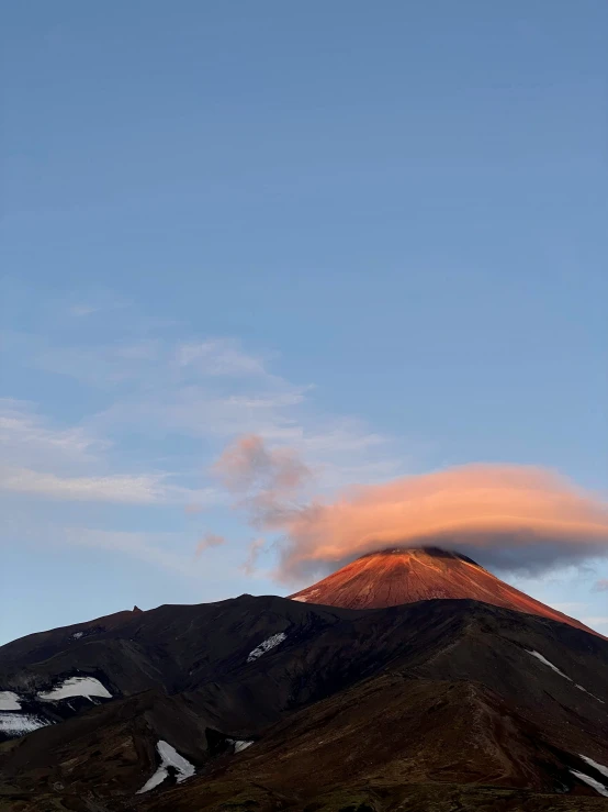 a distant cloud hovers above a high hill