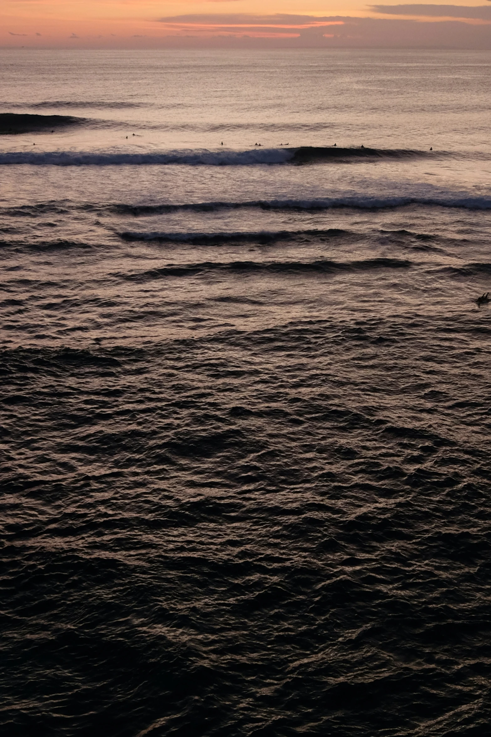 a view of a beach at sunset looking towards water