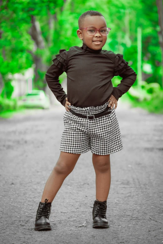 little girl standing with one foot on the ground and one leg behind her