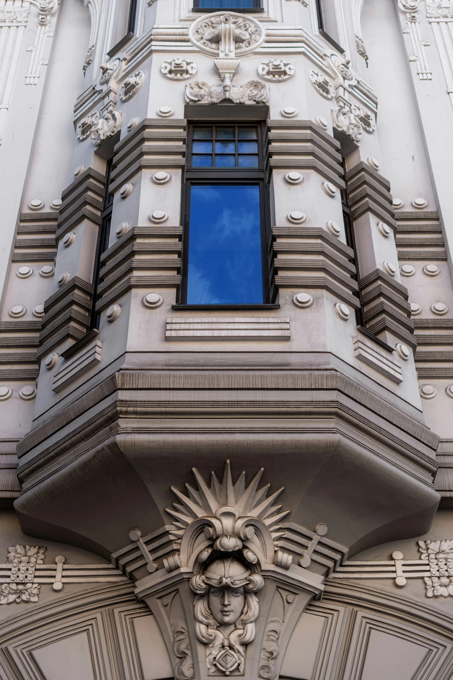 the facade of a very large building with a big clock