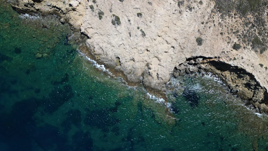 an aerial view of cliffs on the ocean