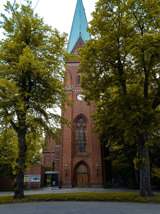 an old church with a steeple is surrounded by trees