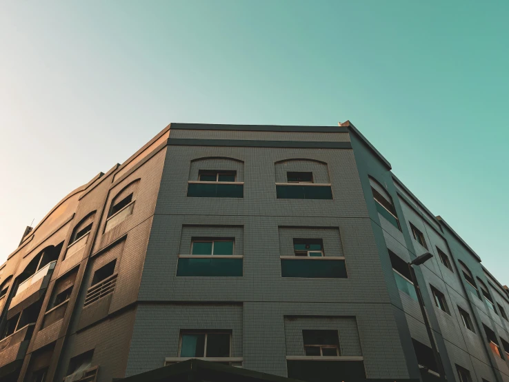 a building with some windows on it, next to a street