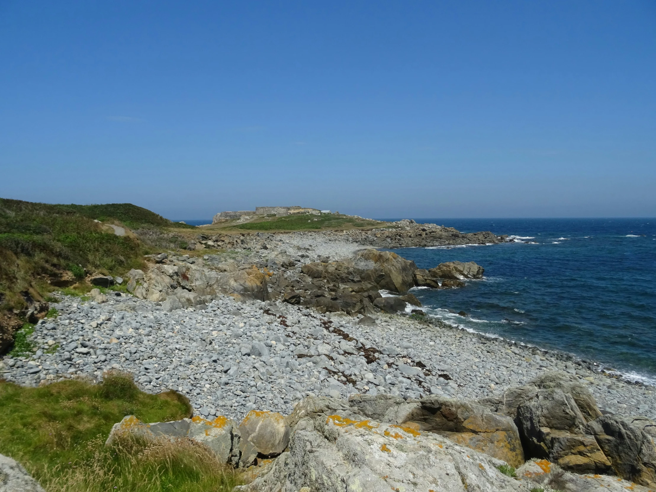 view of water and rocks on shore of beach