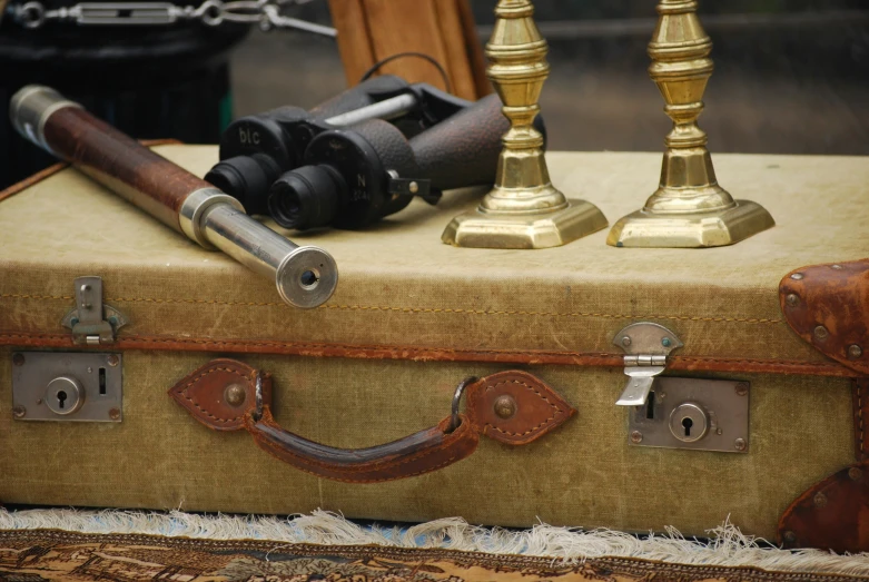 a pair of golden candles and a pair of black telescope