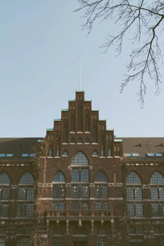 a large red brick building surrounded by many windows