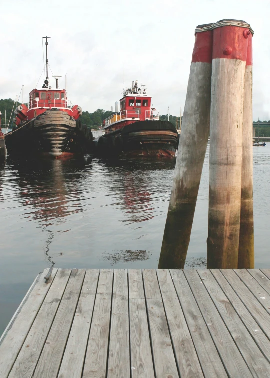 four boats docked at a harbor with two inflatable floats