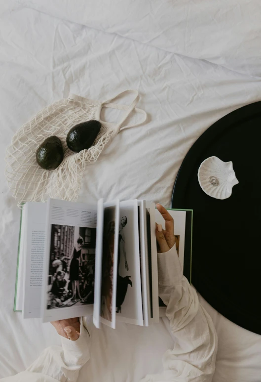 a woman reading a book in bed