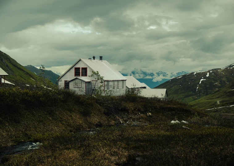 a white building is on the side of a hill