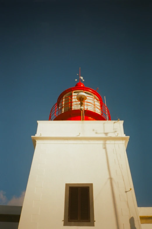 a lighthouse is shining with its red lights on