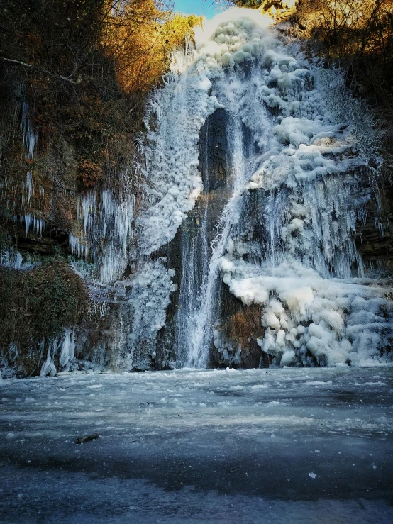 the frozen waterfall is melting down at a small moment