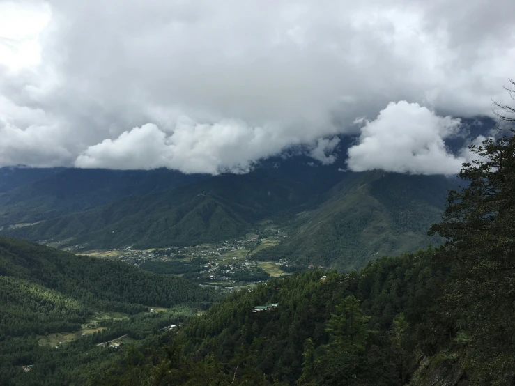 view of mountain peaks with clouds over them