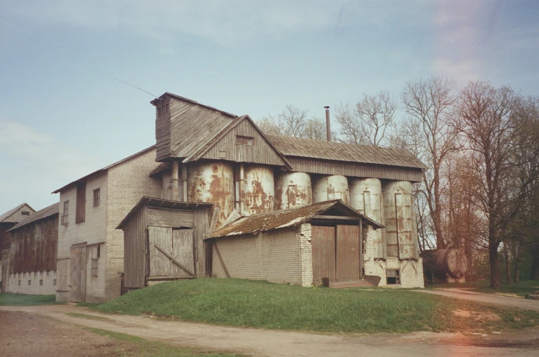 an old wooden barn with faded paint and tints