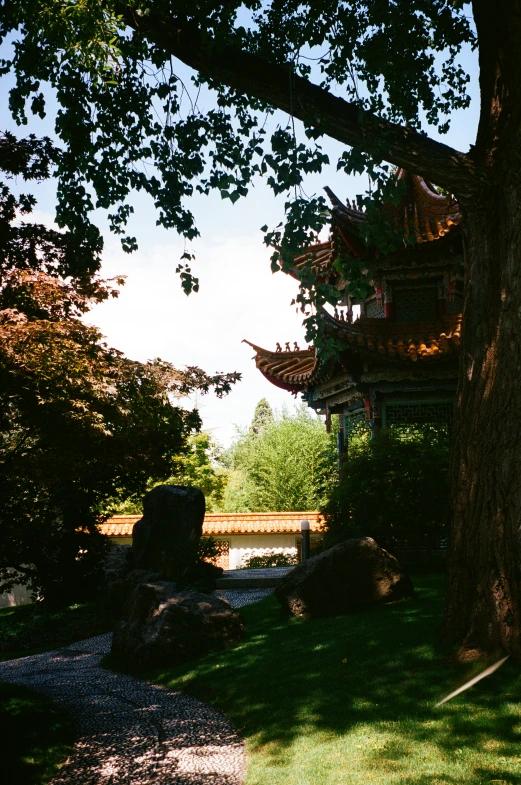 a well lit temple is surrounded by a park area