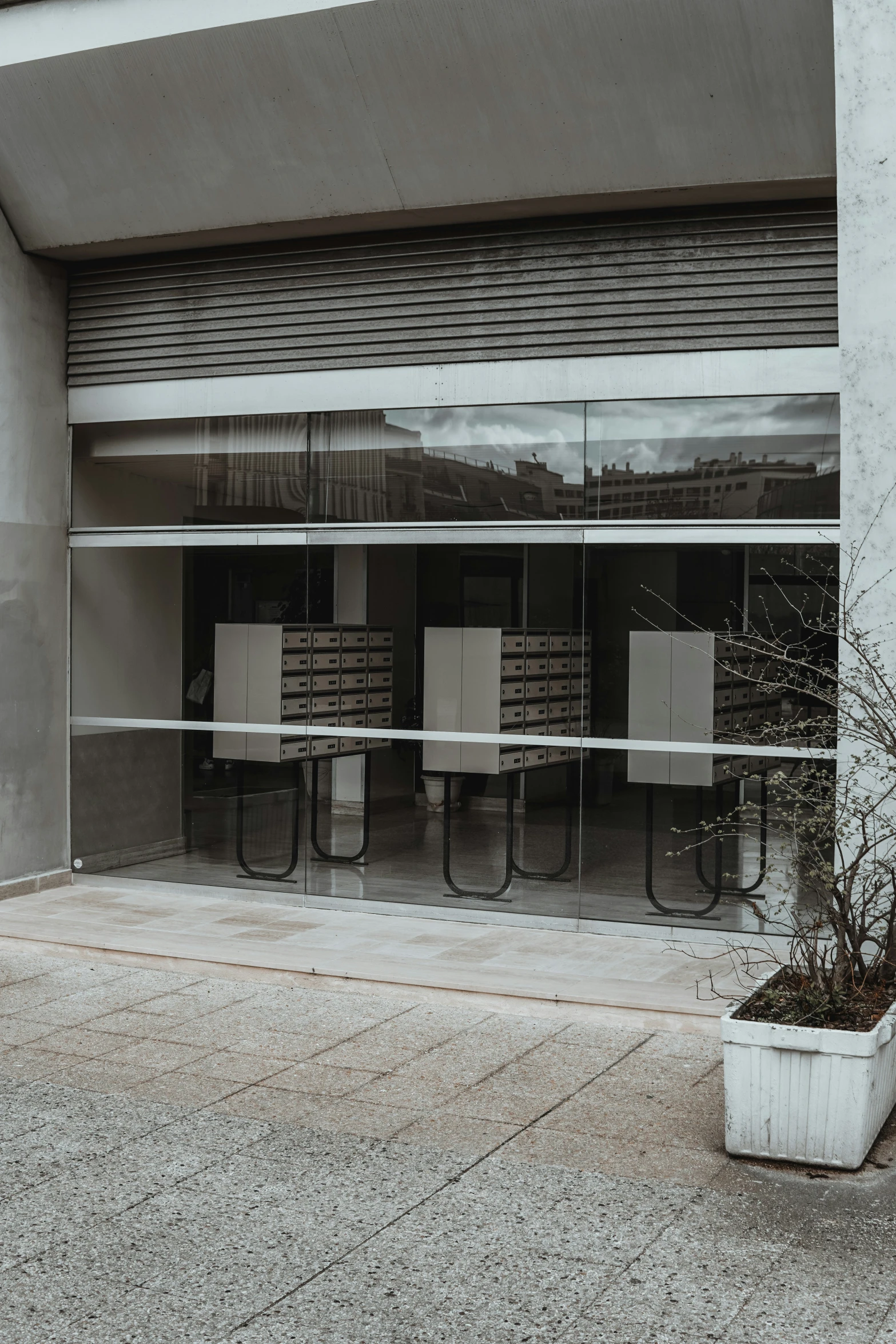 a street corner with a cement building and metal fence