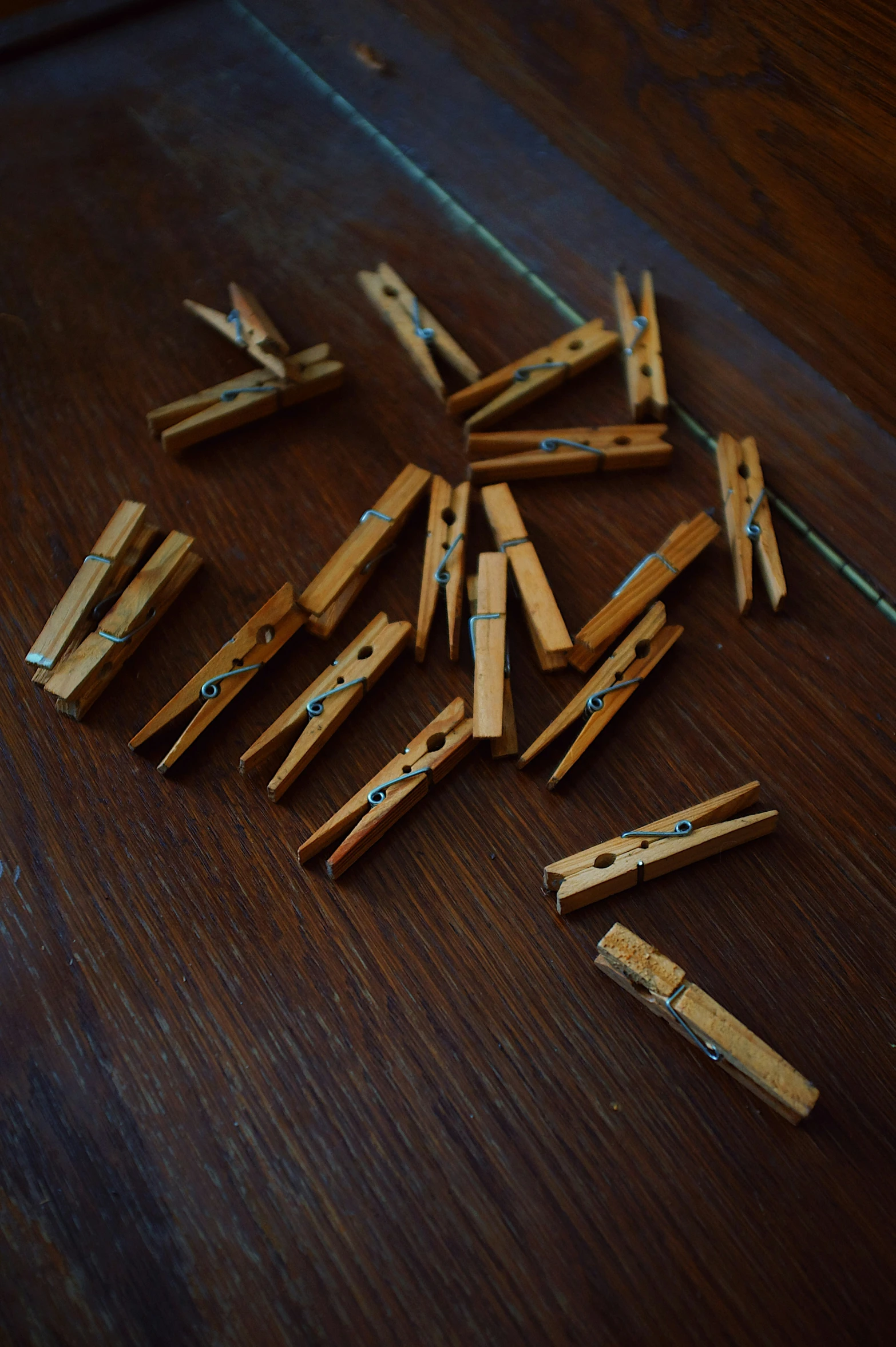 some pieces of wooden clothes pegs that are laid on a table