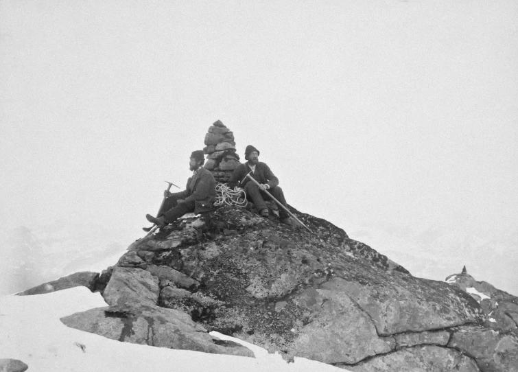 black and white po of four people on a rocky outcropping