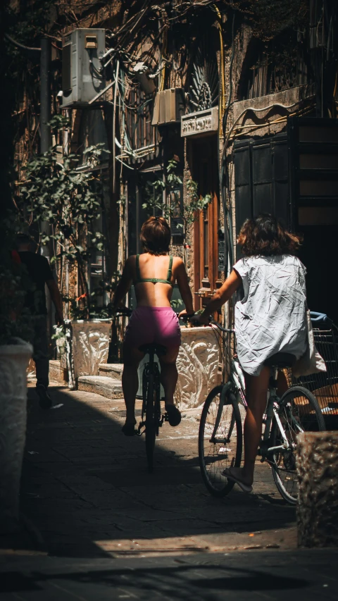 a bicyclist and a woman both ride in opposite directions